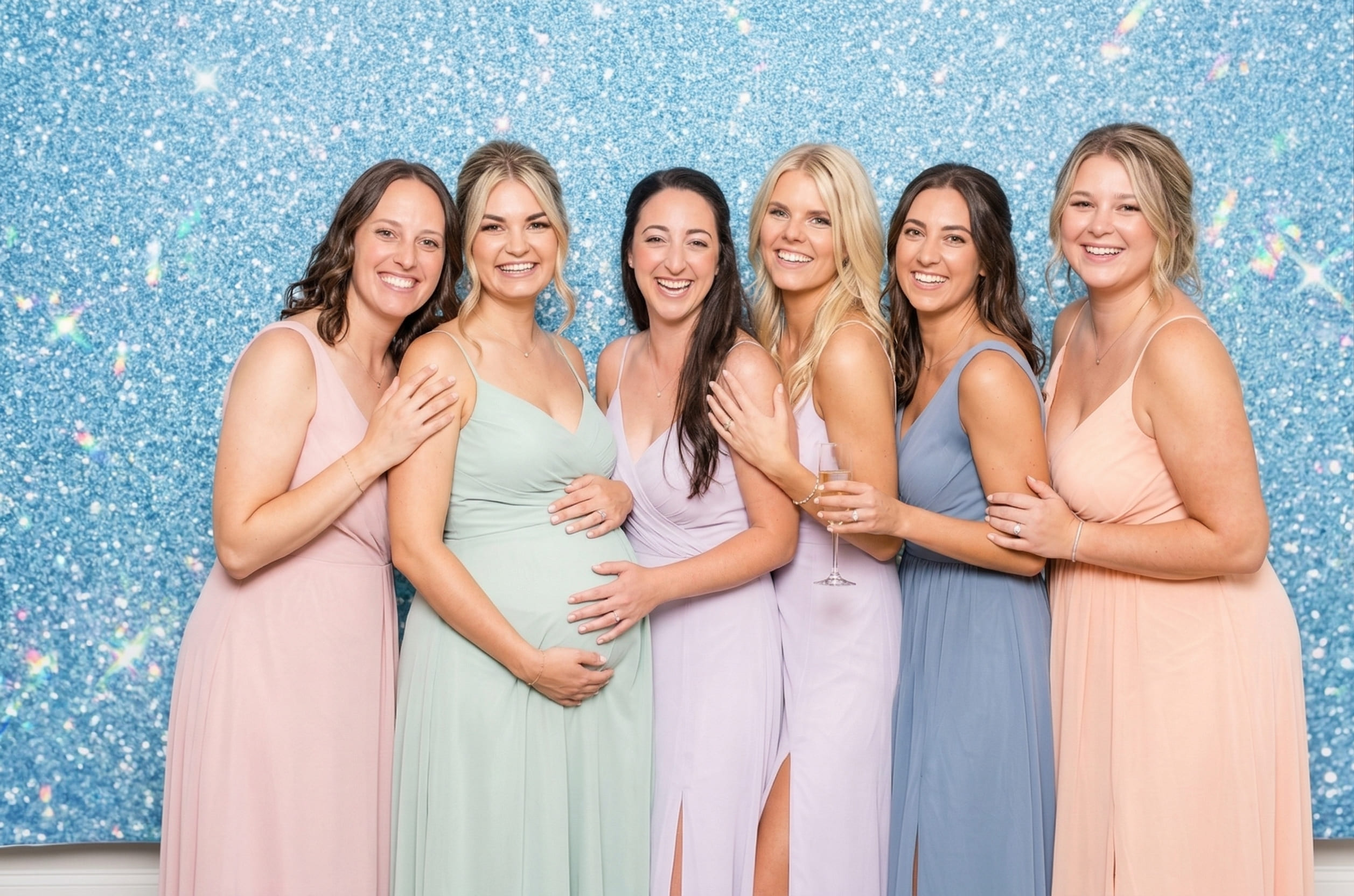Guests celebrating at a gender reveal photo booth in Calgary